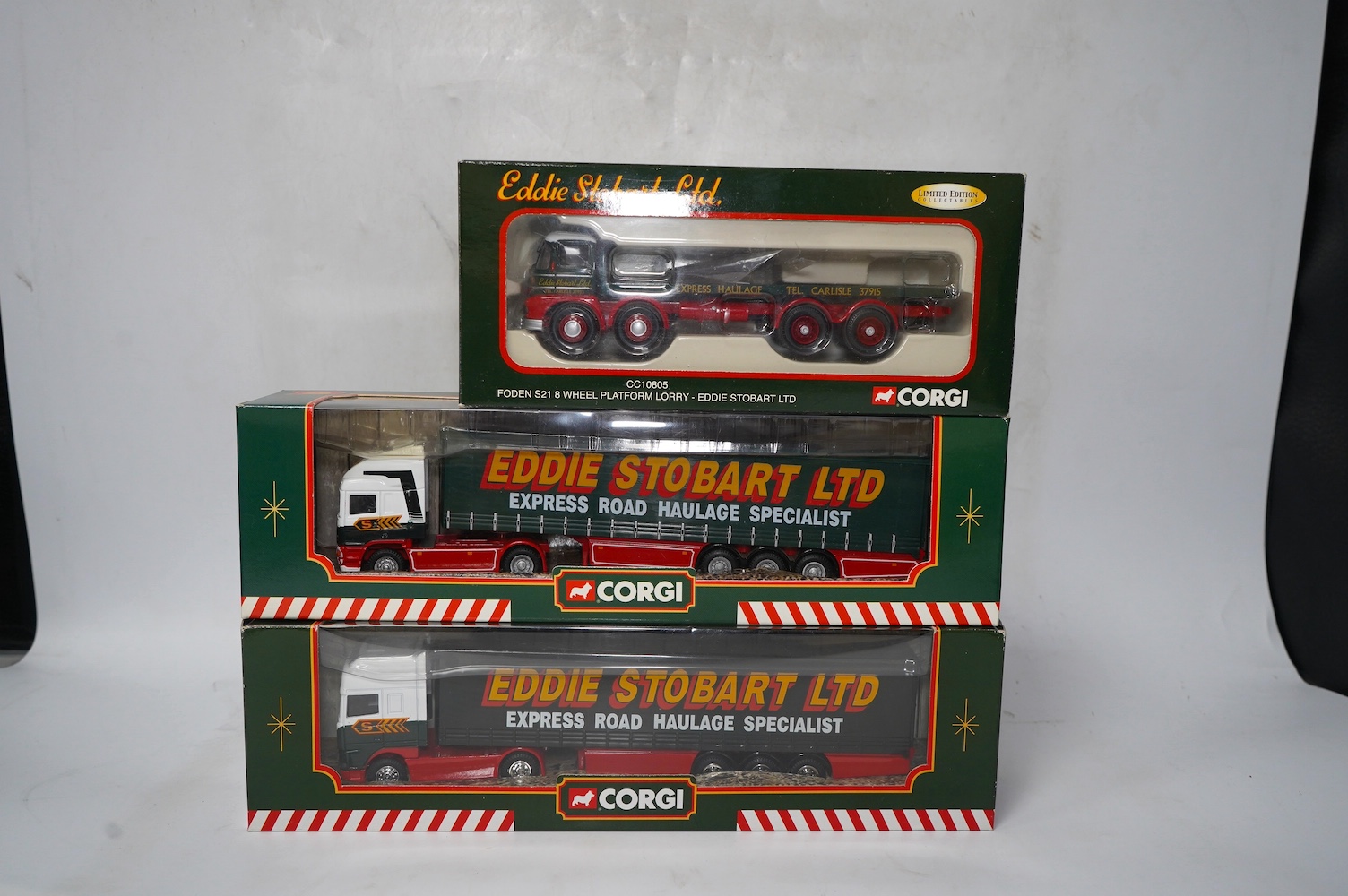 Fourteen boxed Corgi diecast Eddie Stobart commercial vehicles, including articulated tractor and trailer units, a Douglas DC-3 aircraft, flatbed lorries, etc. Condition - good.